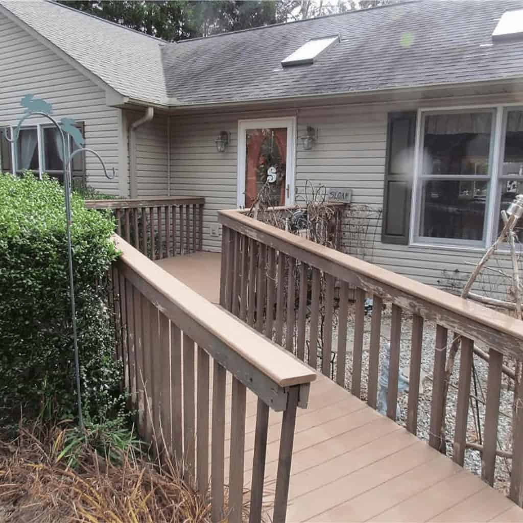 A wooden walkway leading to a house.