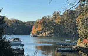 A boat docked in a lake with trees in the background.