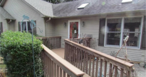 A wooden walkway leading to a house.