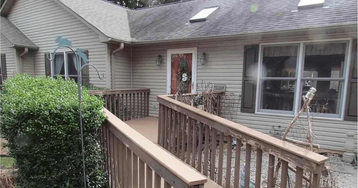 A wooden walkway leading to a house.